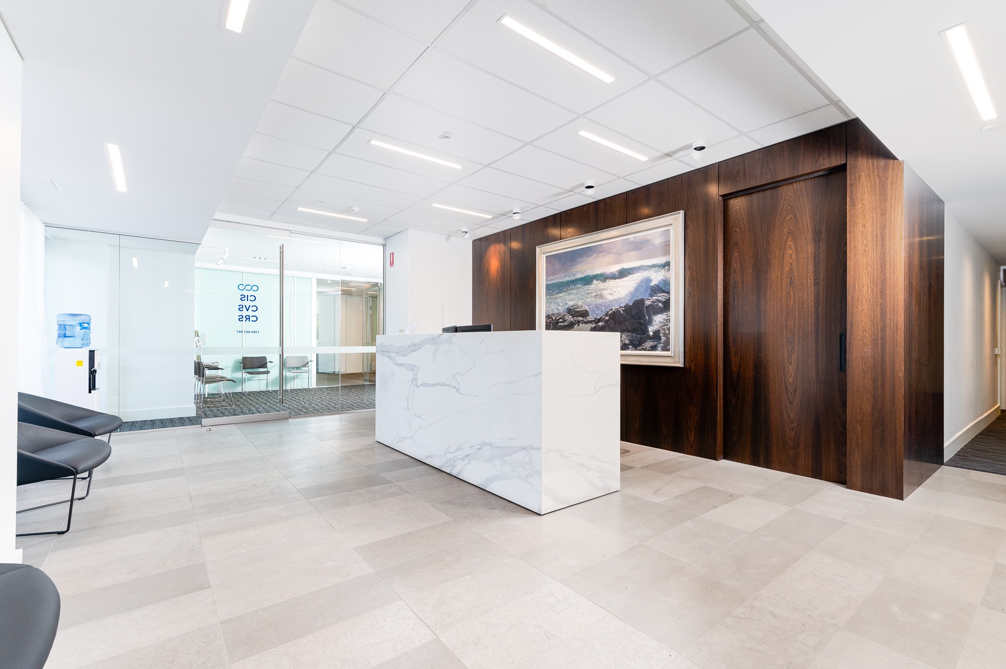 Modern reception desk with timber feature wall