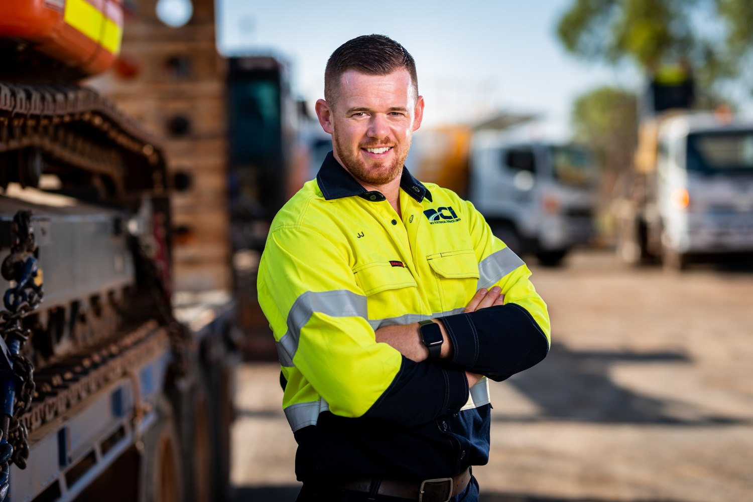 Workplace portrait in high-visibility clothing beside equipment
